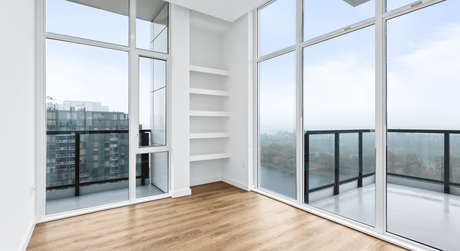 a room with wood floors and windows