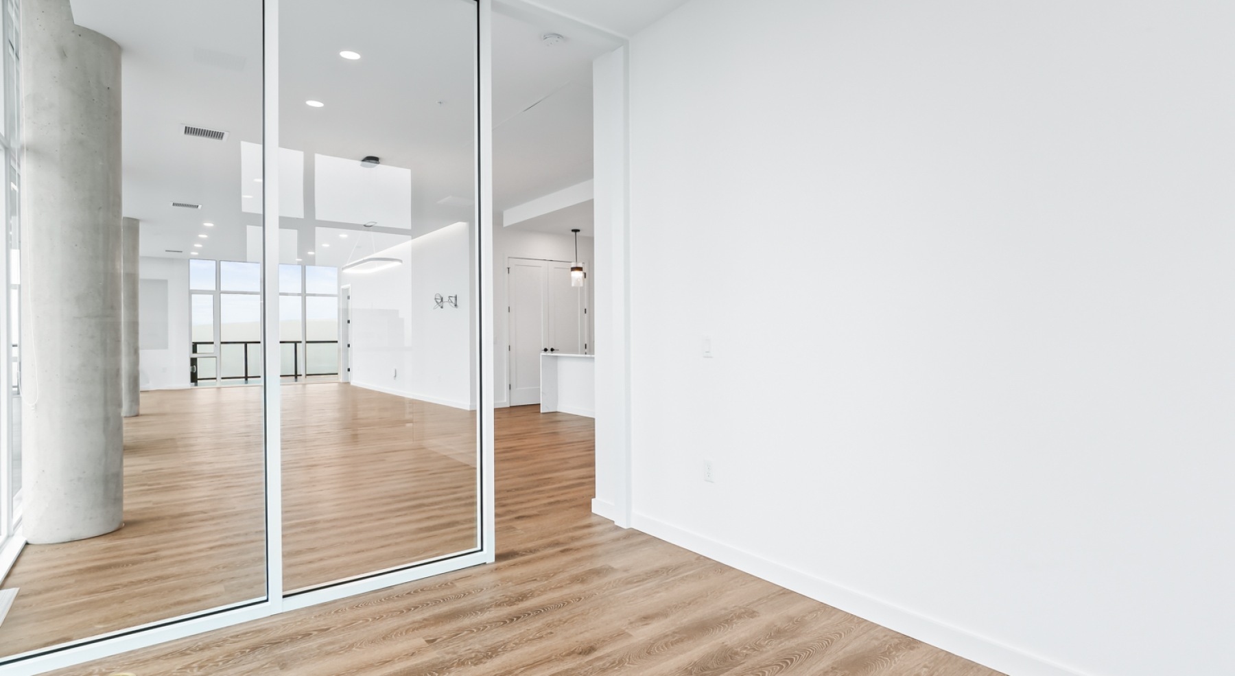 a room with white walls and wood floors