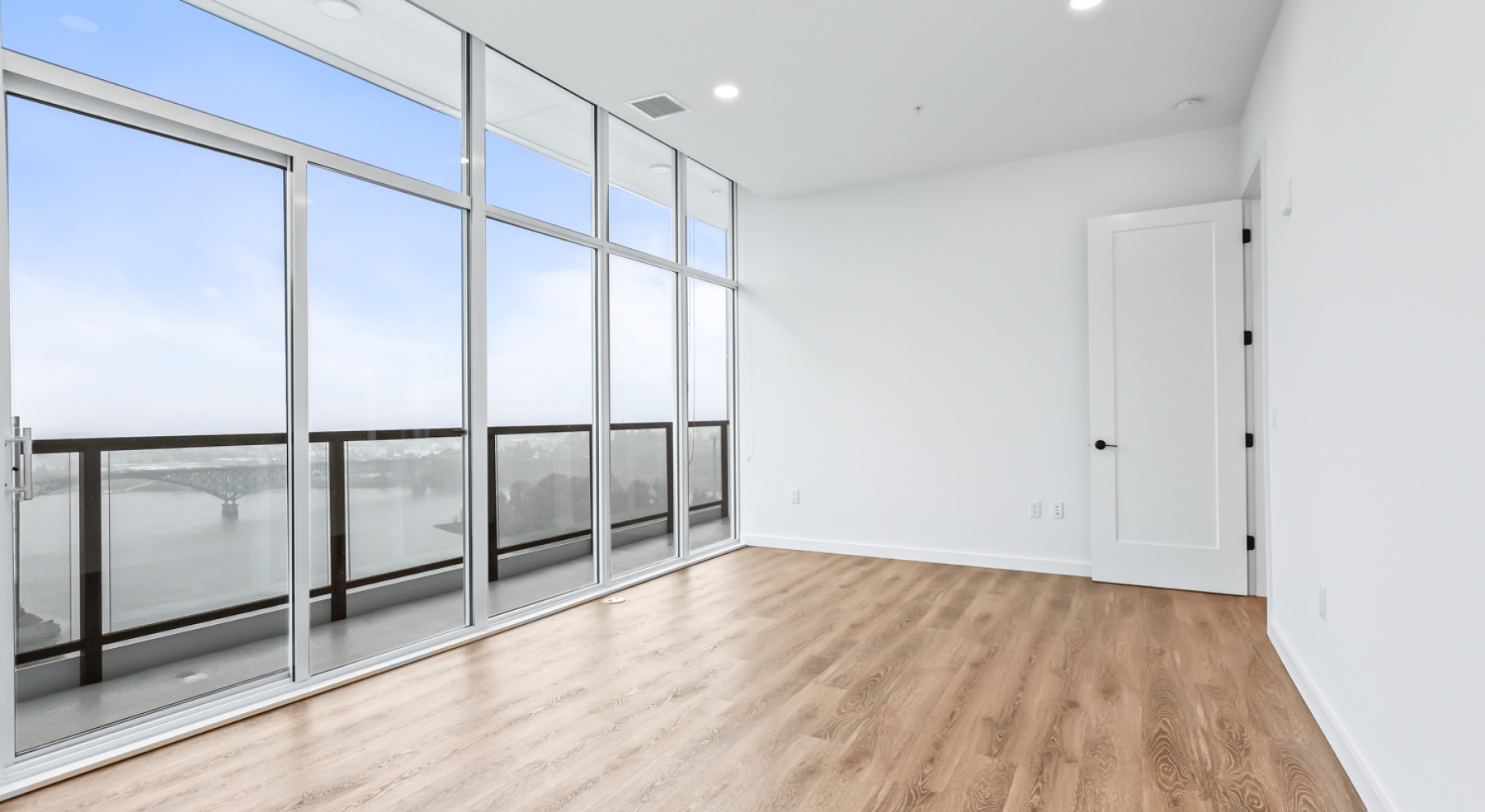 a room with white walls and wood floors