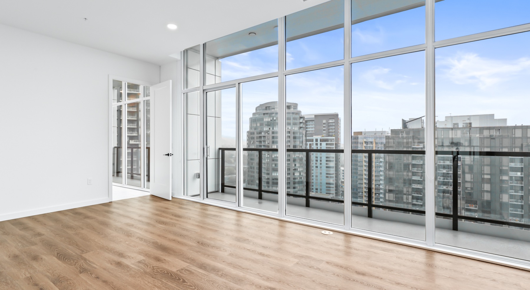 a room with white walls and wood floors