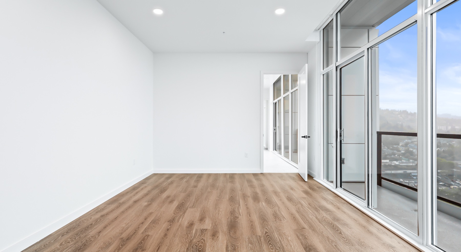 a room with white walls and wood floors