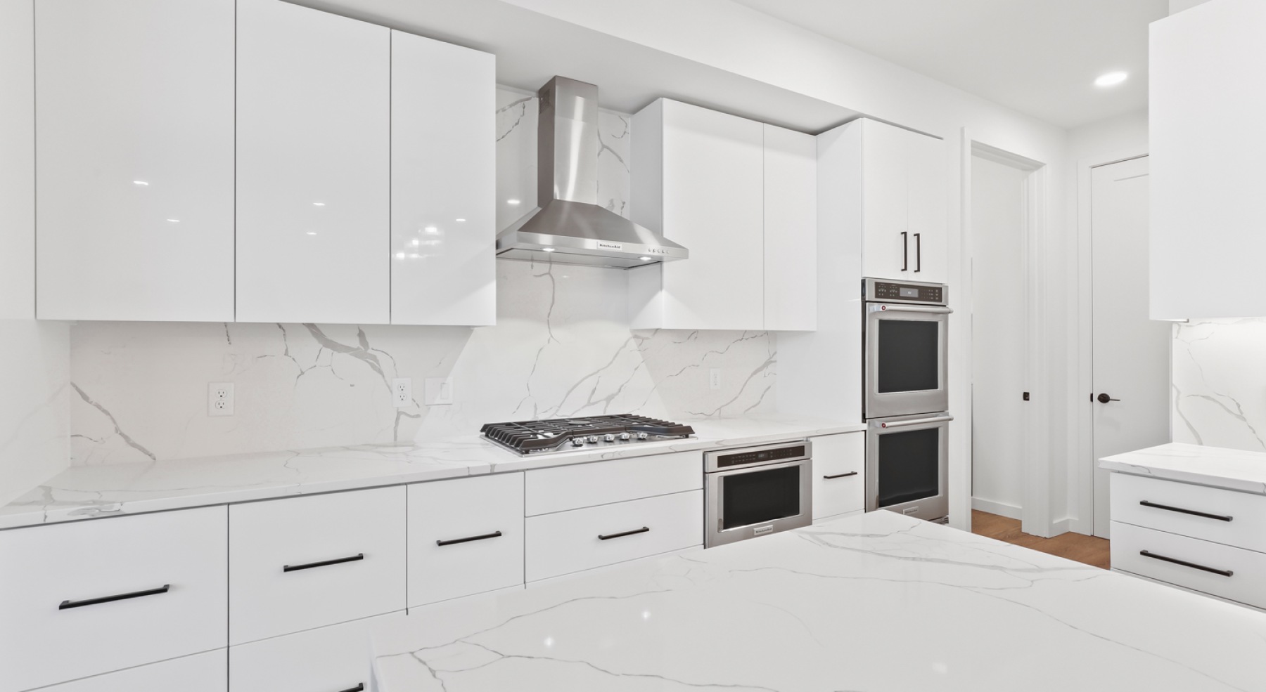 a kitchen with white cabinets