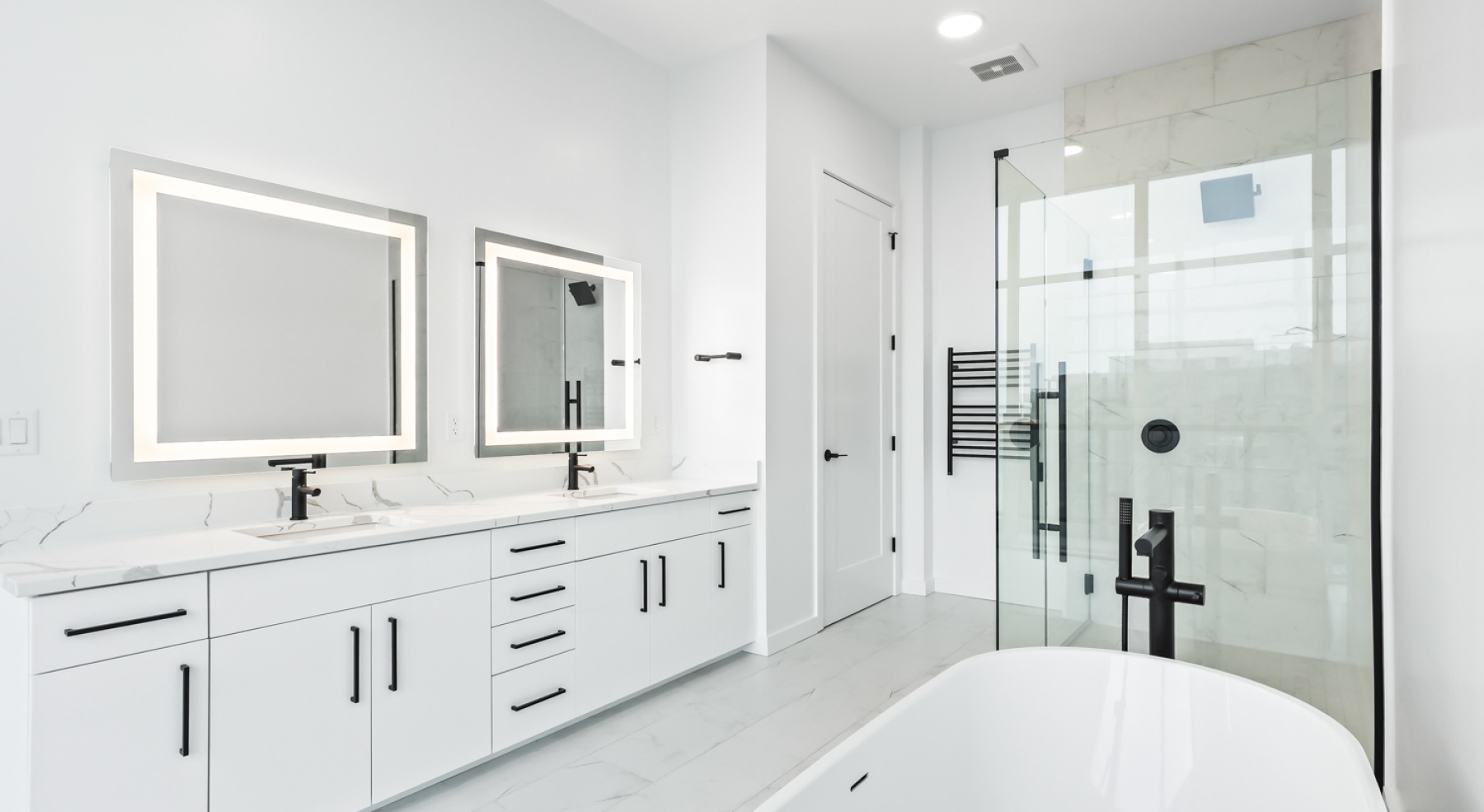 a bathroom with a sink, mirror and shower