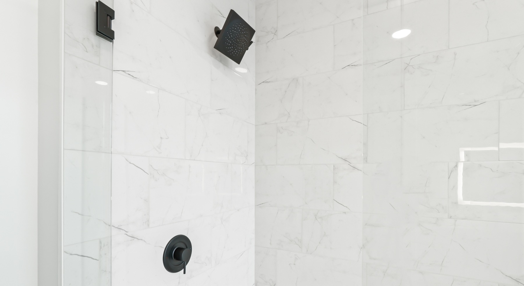 a shower with white tiles