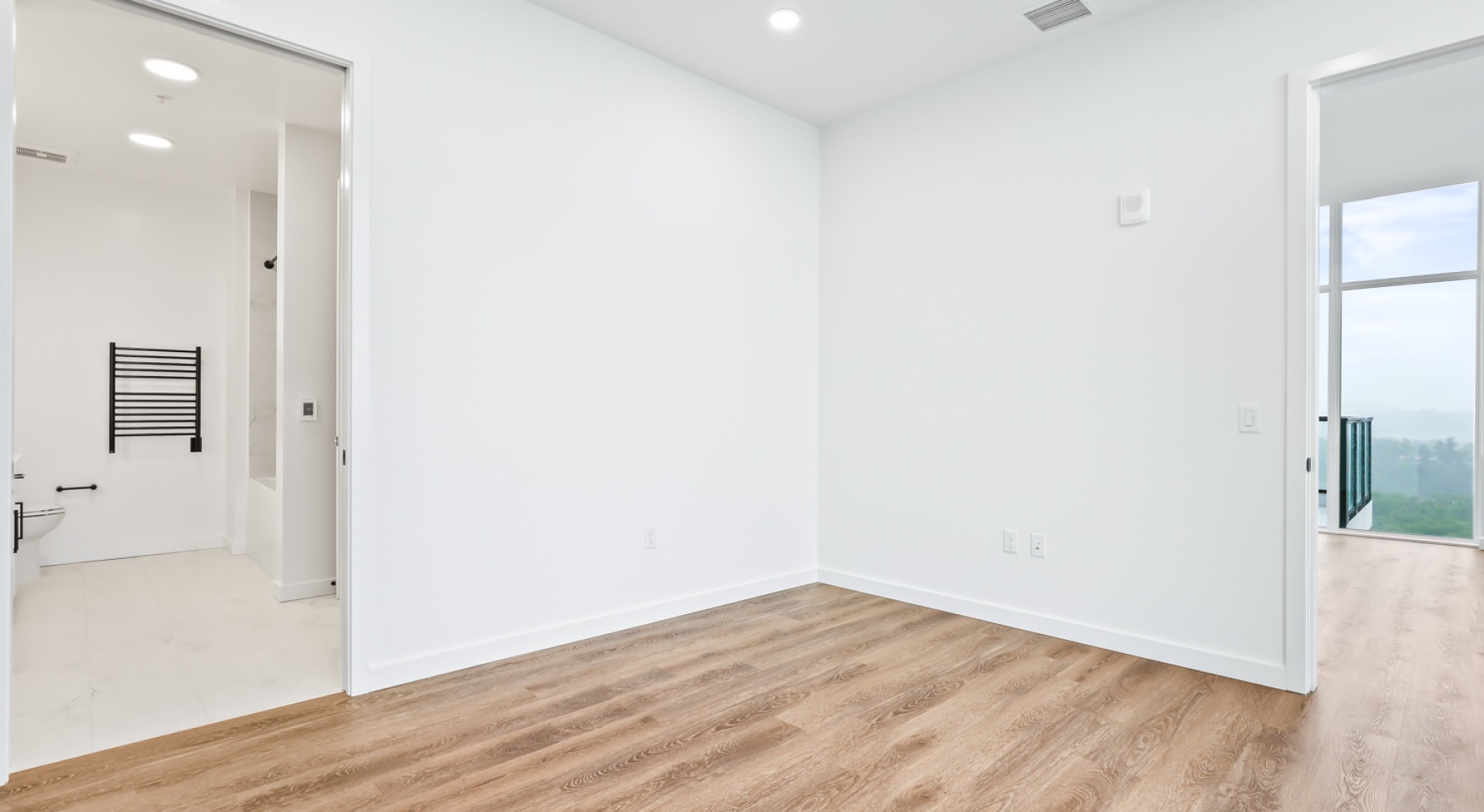 a room with white walls and wood floors